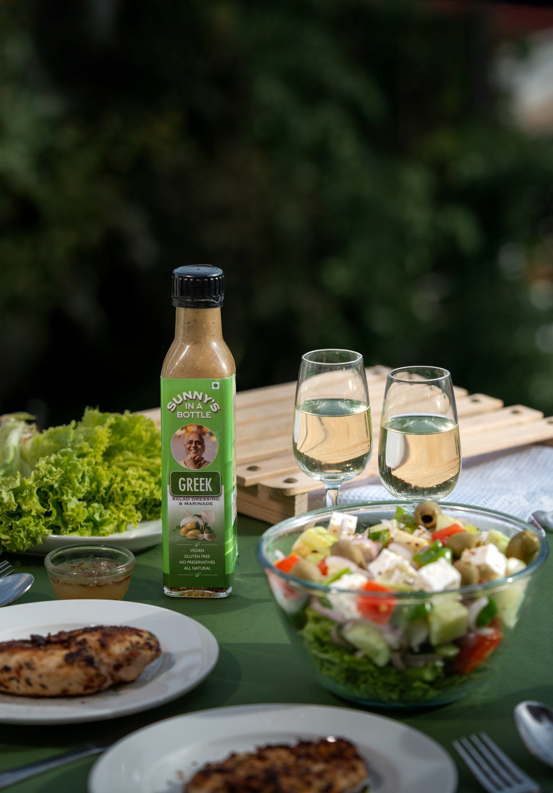 Sunny's In A Bottle Greek dressing with garden salad at dusk
