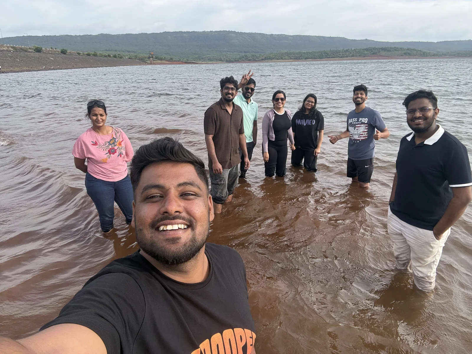 Social Santa team on an offsite, wading in a lake